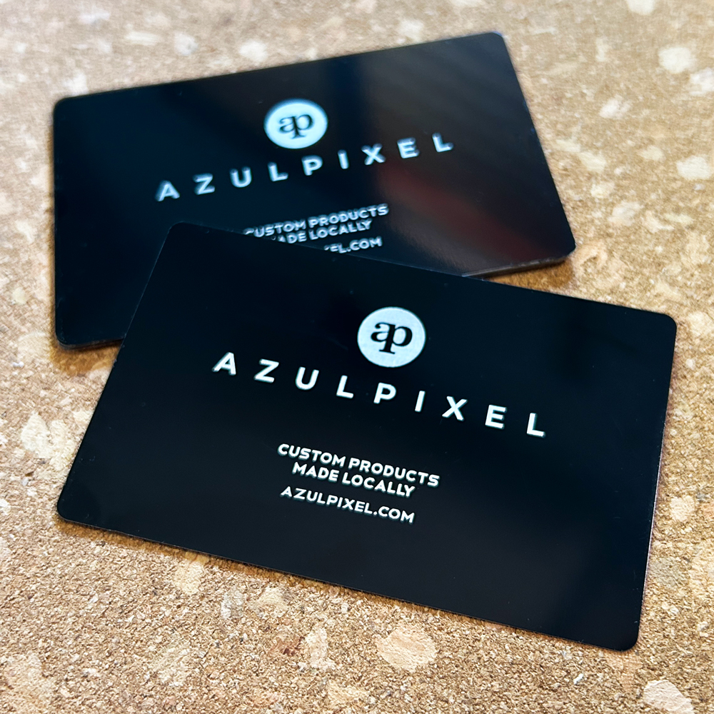 Black anodised aluminium business cards with the Azul Pixel logo